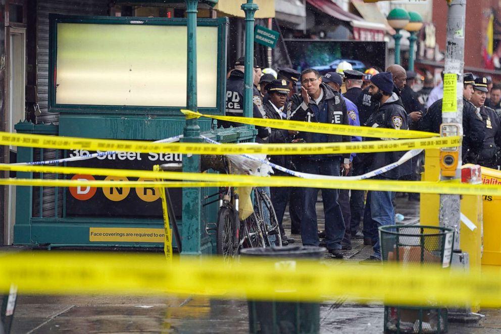 PHOTO: New York City Police personnel gather at the entrance to a subway stop in the Brooklyn borough of New York, Tuesday, April 12, 2022. Multiple people were shot and injured at a subway station during a morning rush hour attack.
