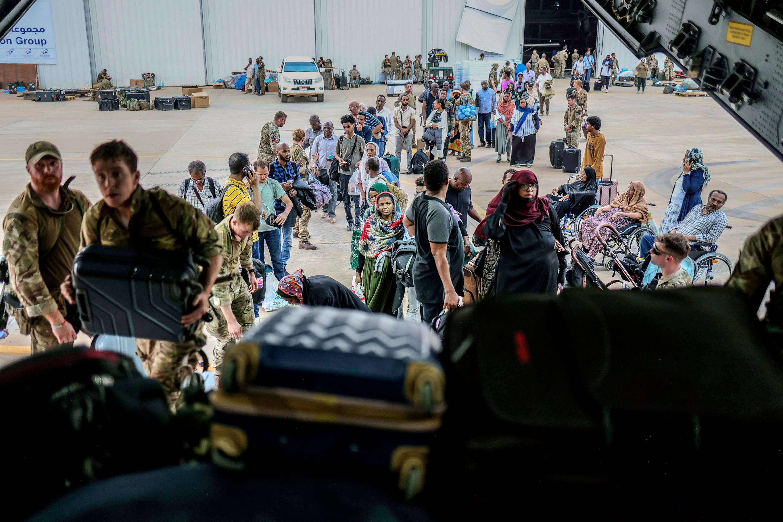 PHOTO: British Nationals prepare to be evacuated onto a RAF aircraft at Wadi Seidna Air Base, in Sudan, April 27, 2023.