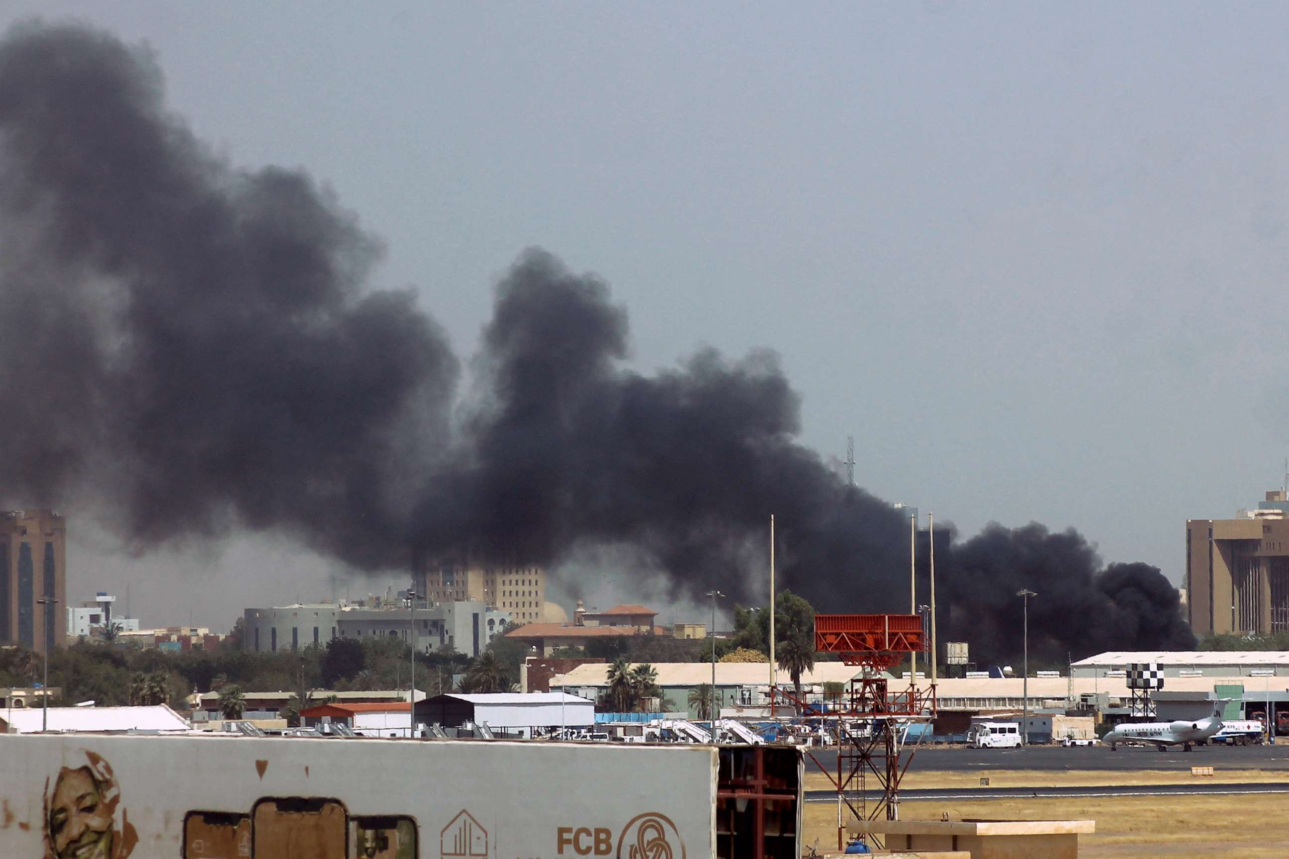 PHOTO: Heavy smoke bellows above buildings in the vicinity of the Khartoum's airport on April 15, 2023, amid clashes in the Sudanese capital.