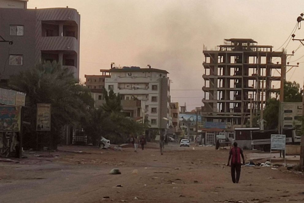 PHOTO: People walk on an almost empty street in southern Khartoum, May 2, 2023.