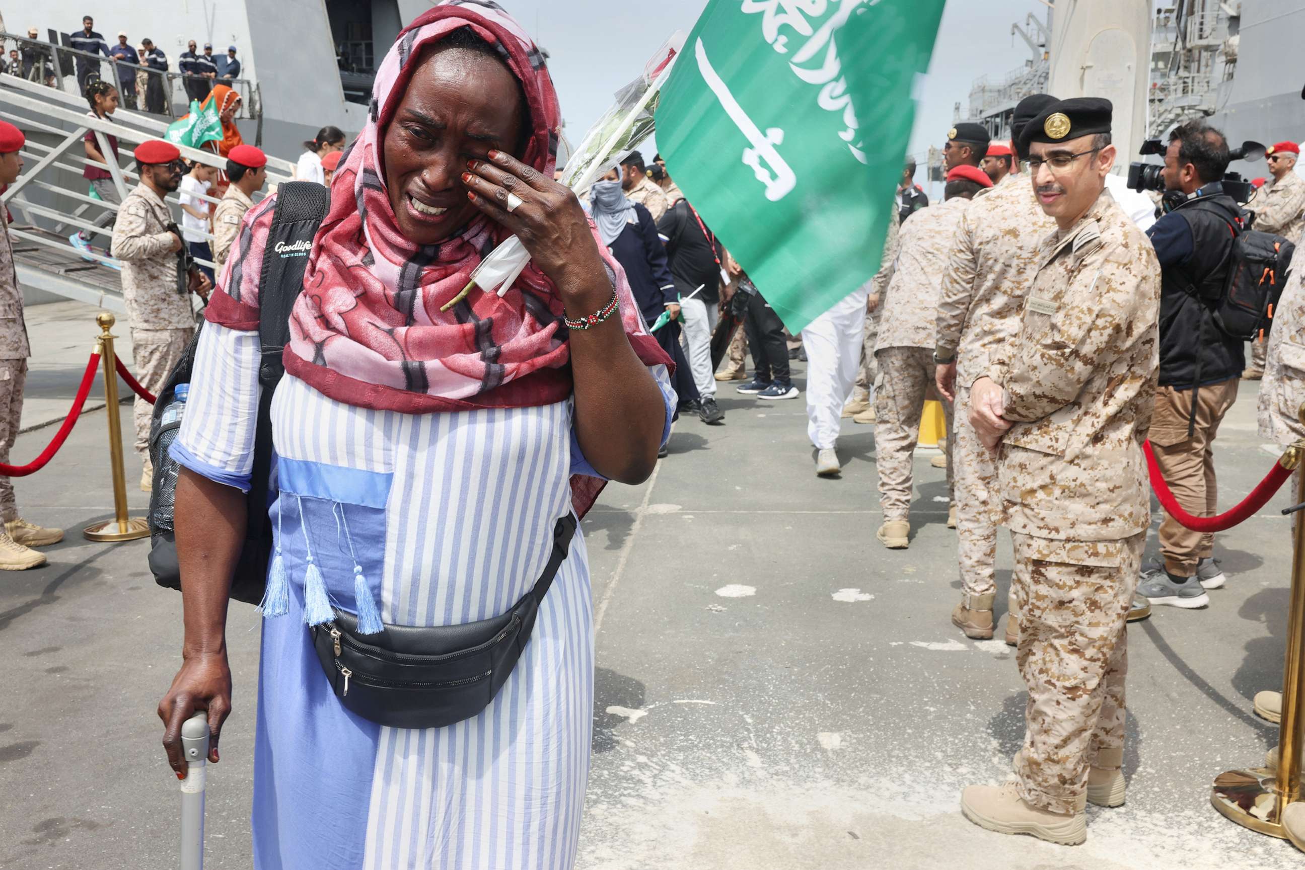 PHOTO: A woman cries as she disembarks from Saudi Navy Ship after being evacuated to Saudi Arabia from Sudan, to escape the conflict, May 8, 2023, at the Jeddah Sea Port, Saudi Arabia.