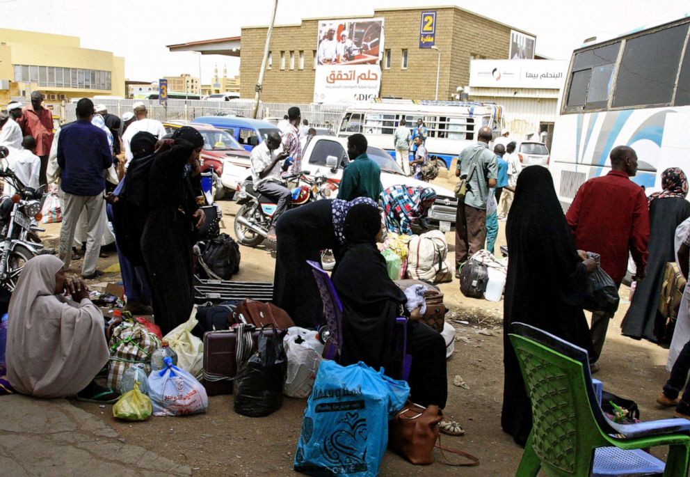 PHOTO: Passengers wait for their shuttle at the main bus station in Khartoum, linking the Sudanese capital with various parts of the country, June 12, 2019. 