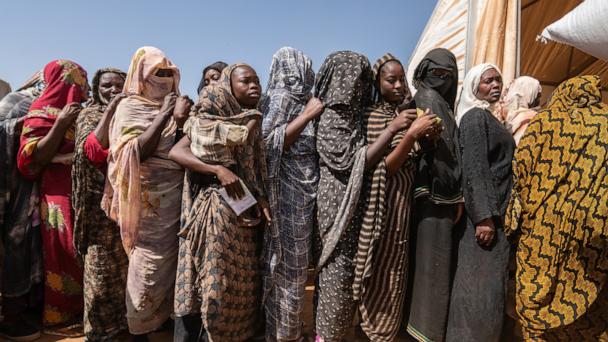 In this Jan. 24, 2025, file photo, displaced Sudanese women from the Khartoum area queue at a World Food Program distribution​ site in Kassala, eastern Sudan.