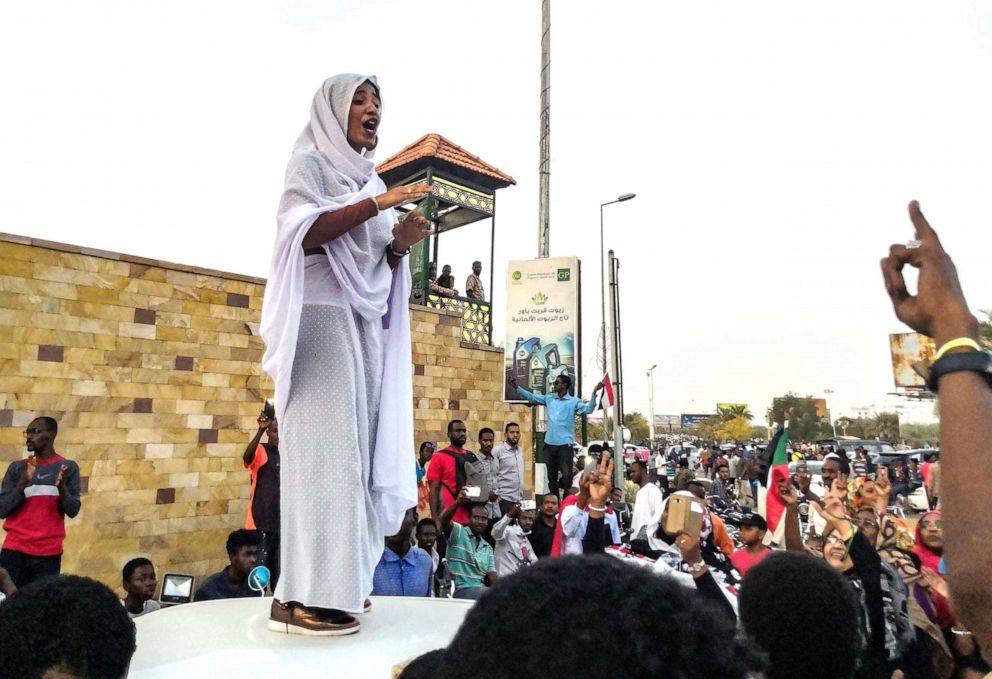 PHOTO: Alaa Salah, a Sudanese woman propelled to internet fame earlier this week after clips went viral  addresses protesters during a demonstration in front of the military headquarters in the capital Khartoum, April 10, 2019.