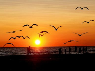 PHOTO: People enjoy the sunset on the beach in Liepaja, Latvia, July 25, 2019, off the coast of the Baltic Sea.