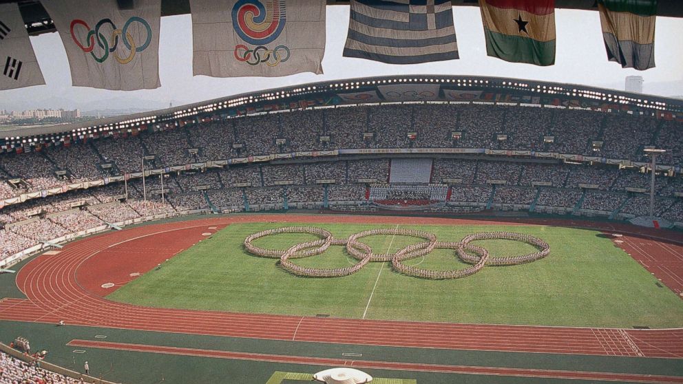 PHOTO: In this Sept. 17, 1988, file photo, flags frame the Olympic Stadium as participants form the Olympic rings on the field during opening ceremonies in Seoul, South Korea. Seoul hosted the Summer Olympics, and North Korea again boycotts in 1988. 