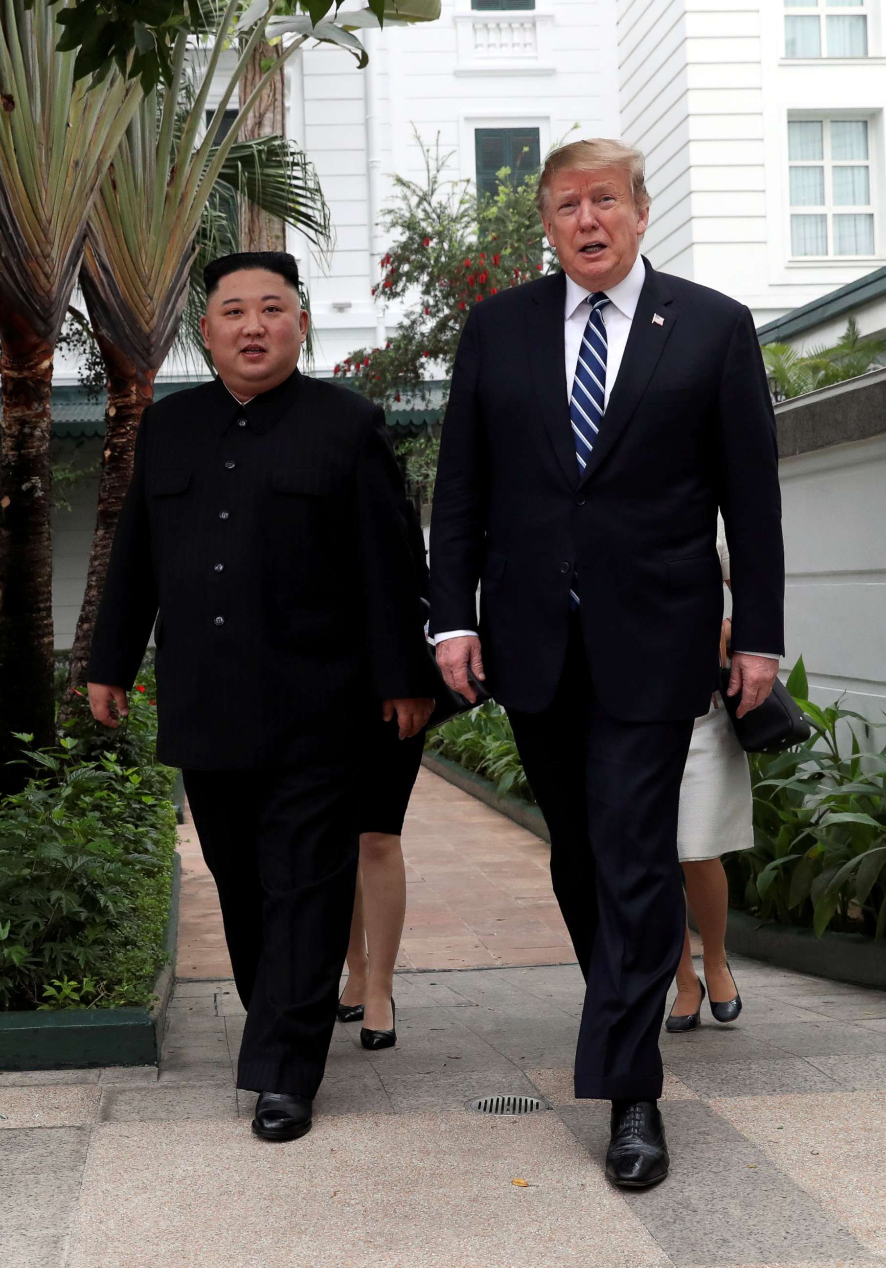 PHOTO: North Korean leader Kim Jong Un and President Donald Trump walk in the garden of the Metropole hotel during the second North Korea-U.S. summit in Hanoi, Vietnam, Feb. 28, 2019. 