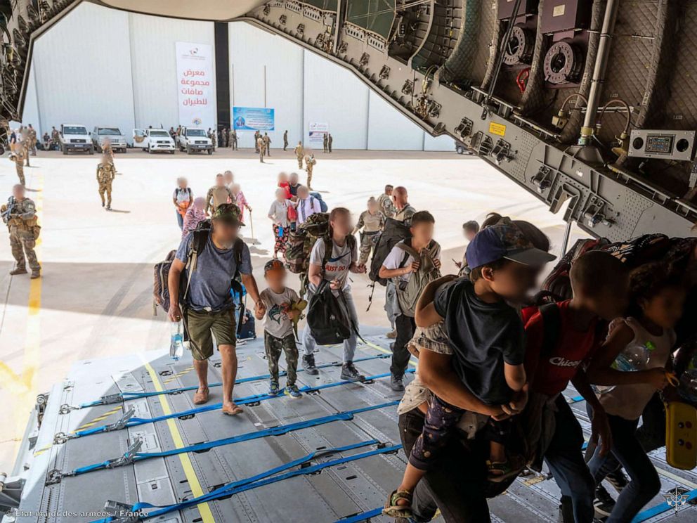 PHOTO:This handout photograph taken on April 23, 2023 and released by the Etat Major des Armees (French defence staff) shows French and other nationalities people as they embark at French military air base in Khartoum to fly to Djibouti.