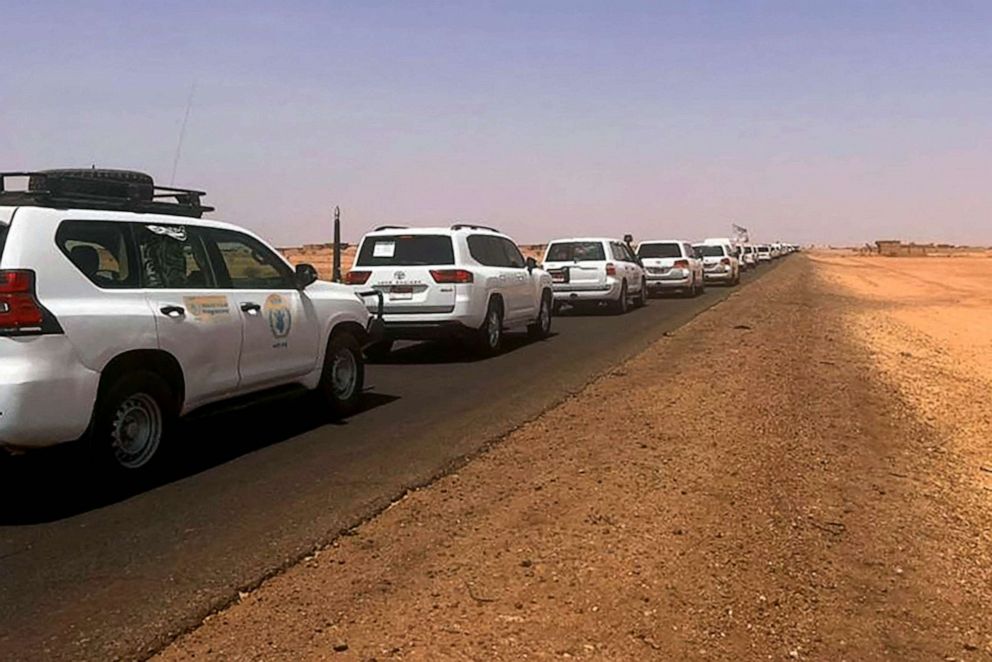 PHOTO: A convoy leaving Khartoum advances on a road towards Port Sudan, April 23, 2023, as people flee the battle-torn Sudanese capital.