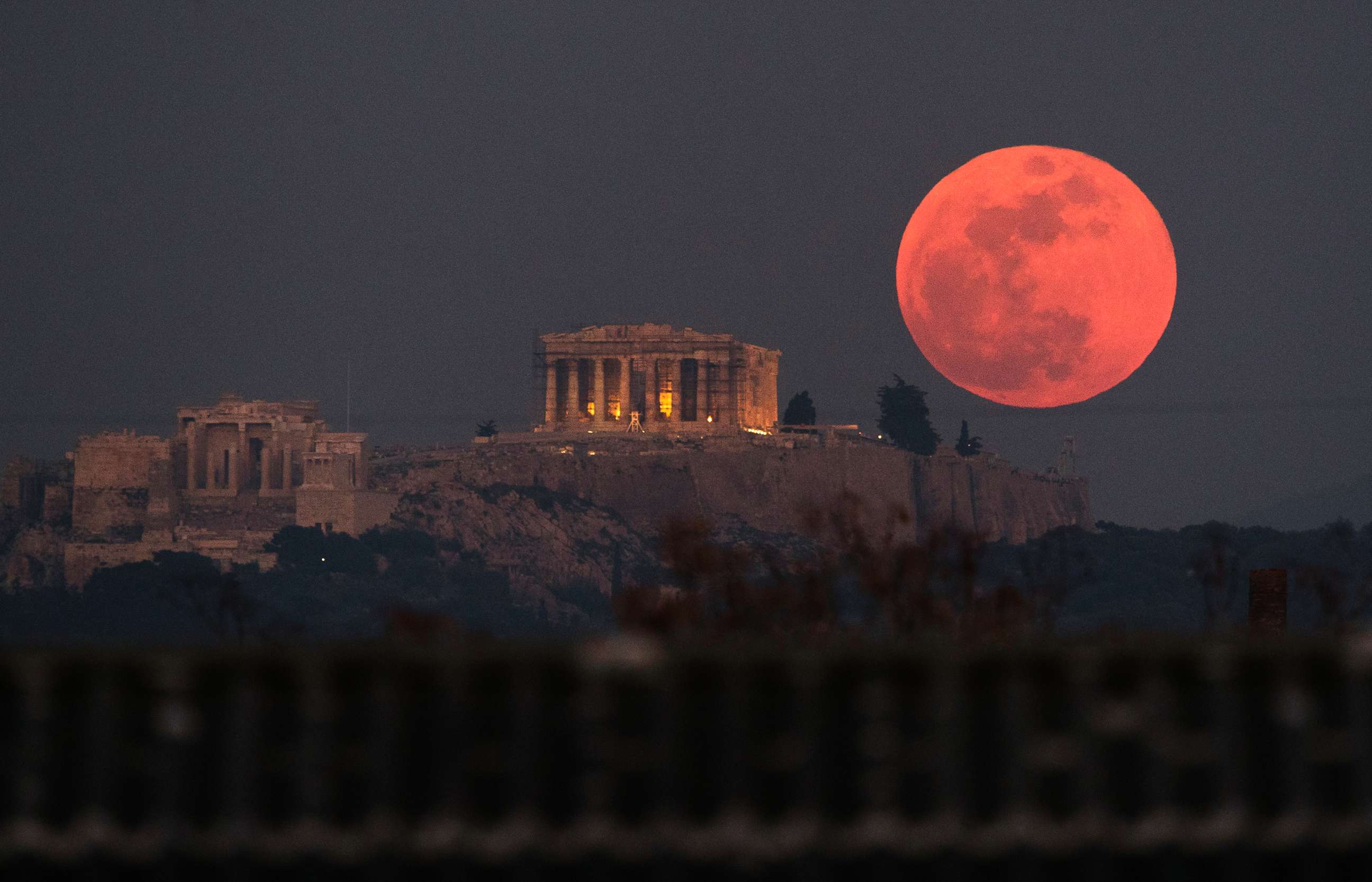 PHOTO: A super blue blood moon rises behind the 2,500-year-old Parthenon temple on the Acropolis of Athens, Greece, on Jan. 31, 2018. 
