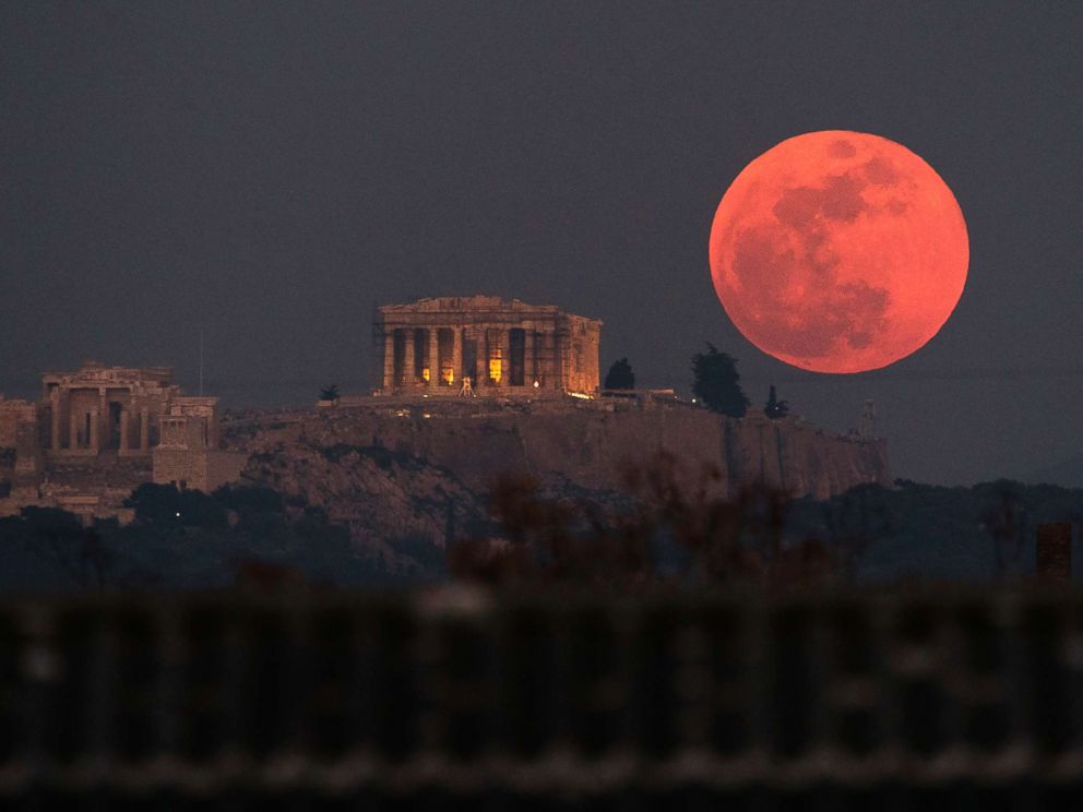   PHOTO: A super blue blood moon rises behind the 2,500-year-old Parthenon temple on the Acropolis of Athens, Greece, on January 31, 2018. 