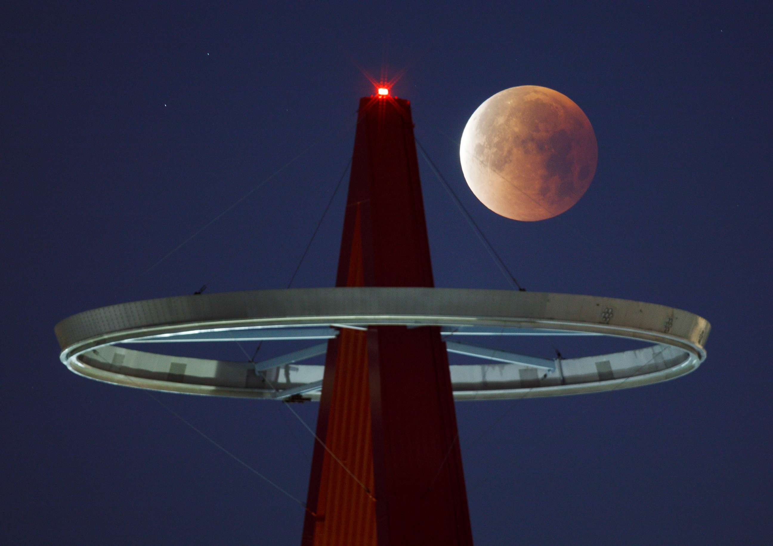 PHOTO: A super moon shines its blood red colors during a full eclipse above the Big A Sign of Angel Stadium in Anaheim, Calif., on Jan., 31, 2018.