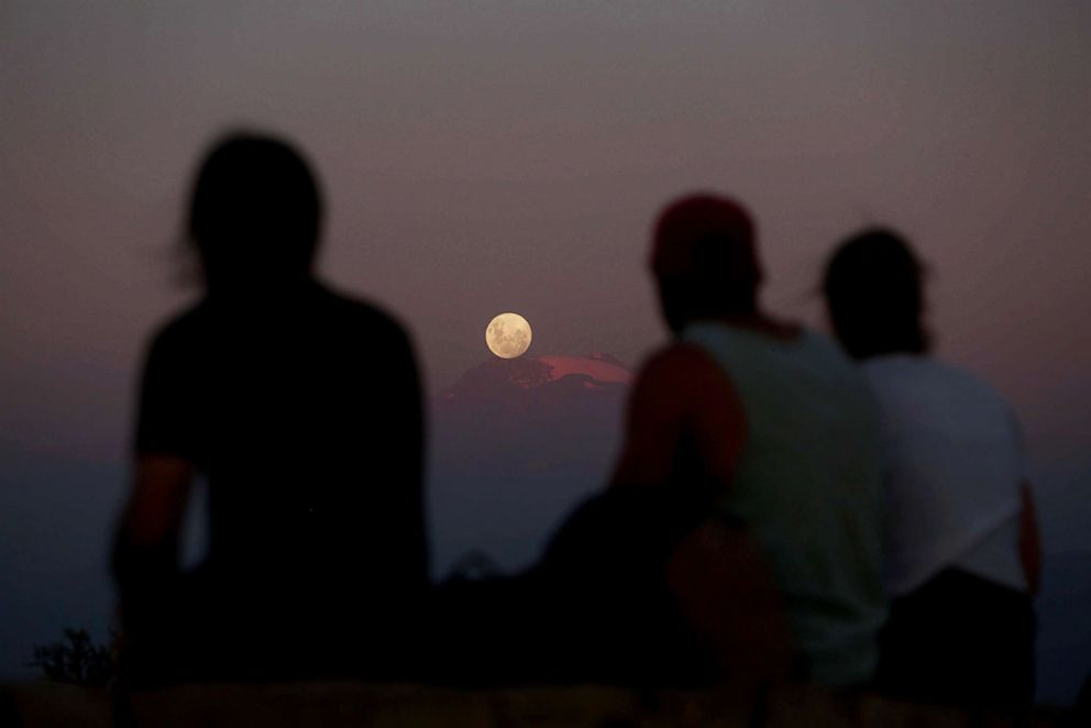 PHOTO: A full moon rises over Los Andes mountain range in Santiago, Chile, Jan. 30, 2018.