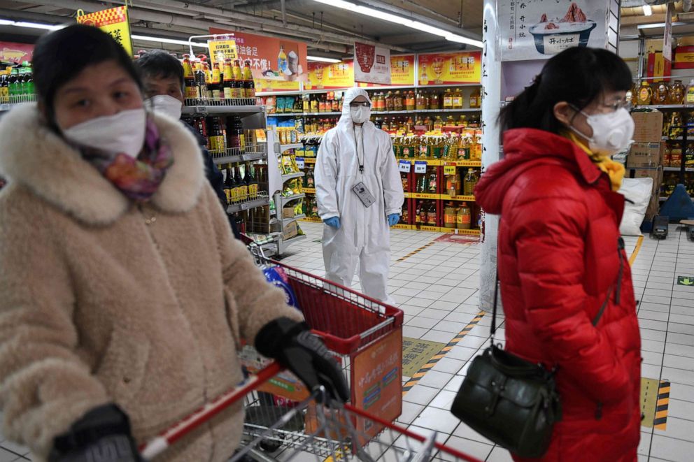 PHOTO: A worker wears protective clothing as a preventive measure against the novel coronavirus as she watches over customers in a supermarket in Beijing, China, on March 3, 2020.