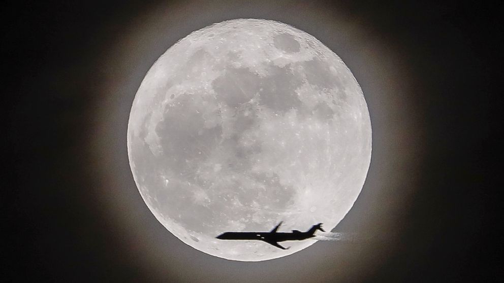 PHOTO: An airplane crosses in front of the moon, a supermoon, in Avondale Estates, Georgia, Dec.3, 2017. 