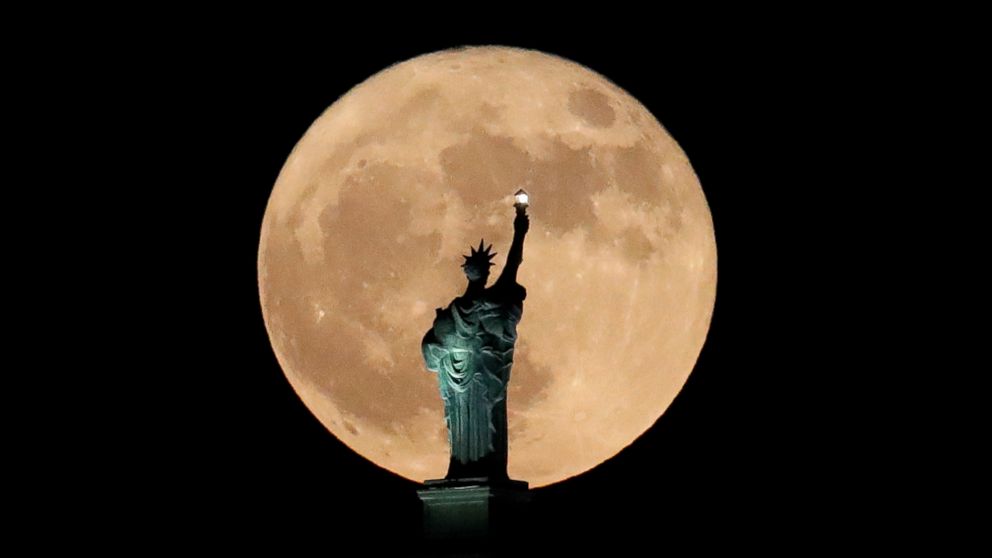 PHOTO: A supermoon rises in front of a replica of the Statue of Liberty sitting atop the Liberty Building in downtown Buffalo, N.Y., Dec. 3, 2017. 
