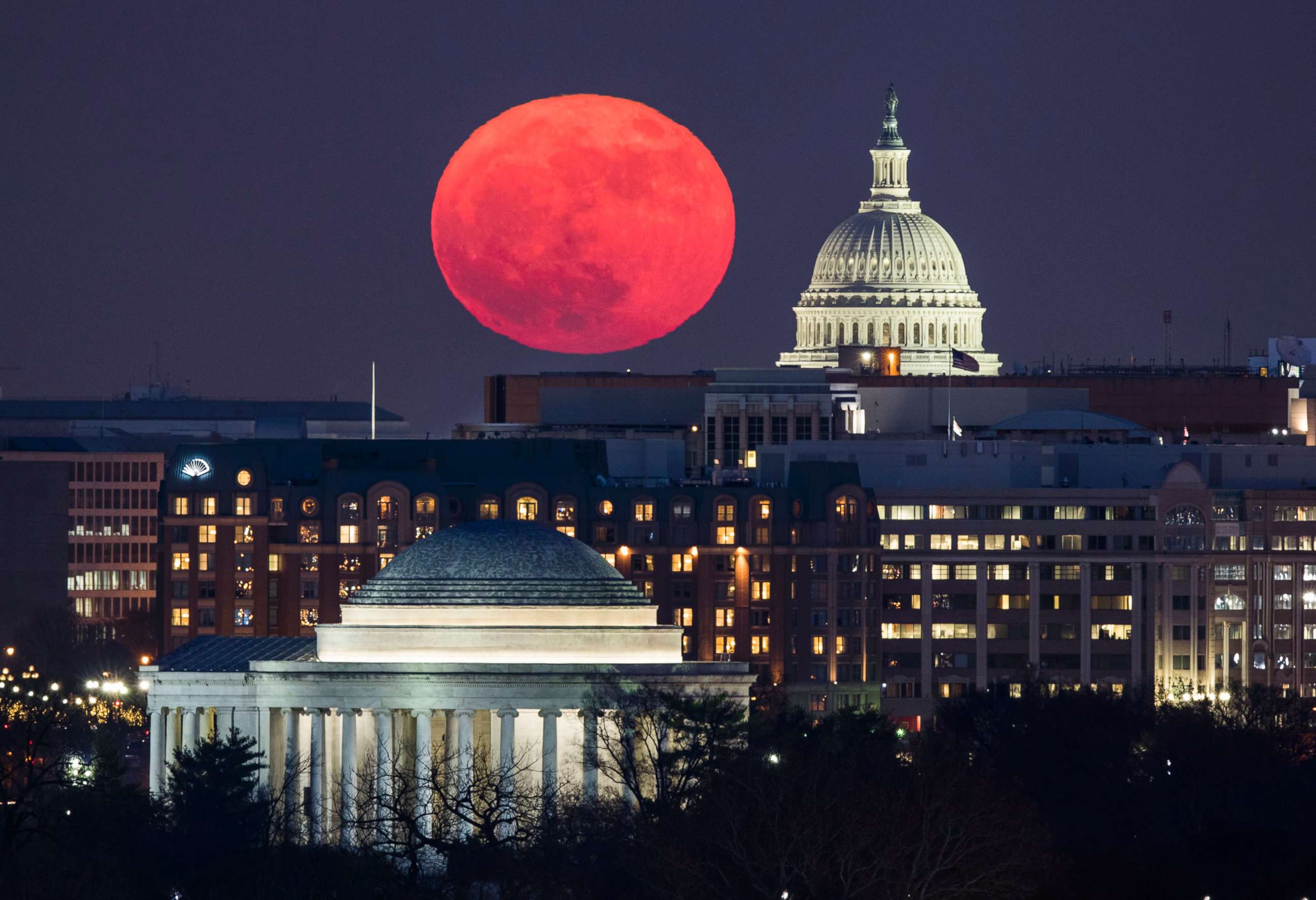 PHOTO: A 'supermoon' rises behind the US Capitol and the Jefferson Memorial, in Washington, DC, viewed from Arlington, Virginia, Dec. 3, 2017. 