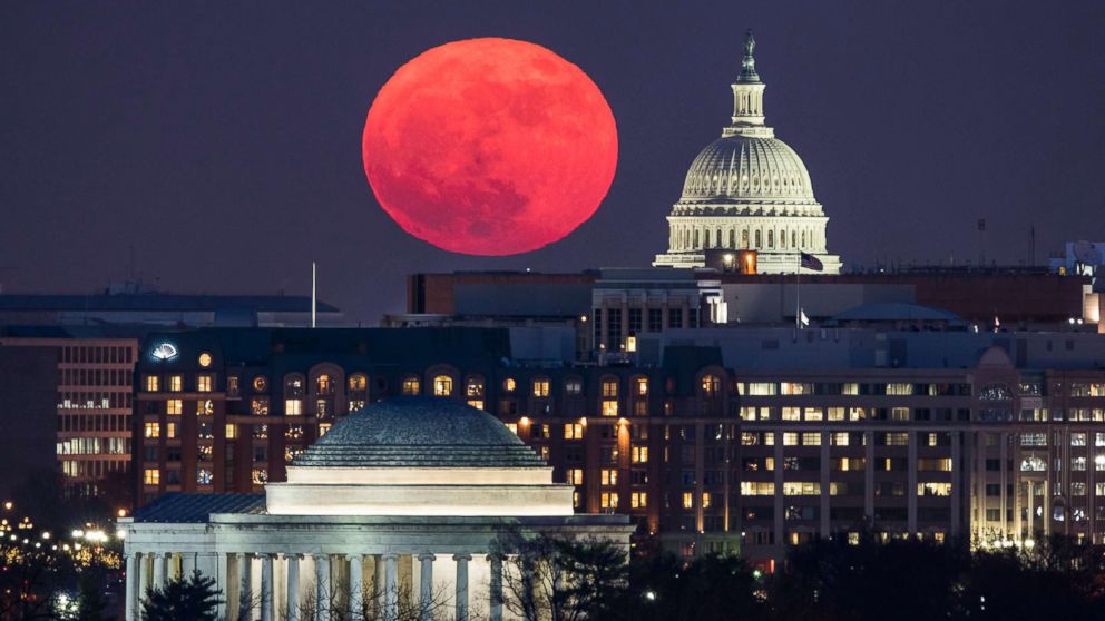 PHOTO: A 'supermoon' rises behind the US Capitol and the Jefferson Memorial, in Washington, DC, viewed from Arlington, Virginia, Dec. 3, 2017. 