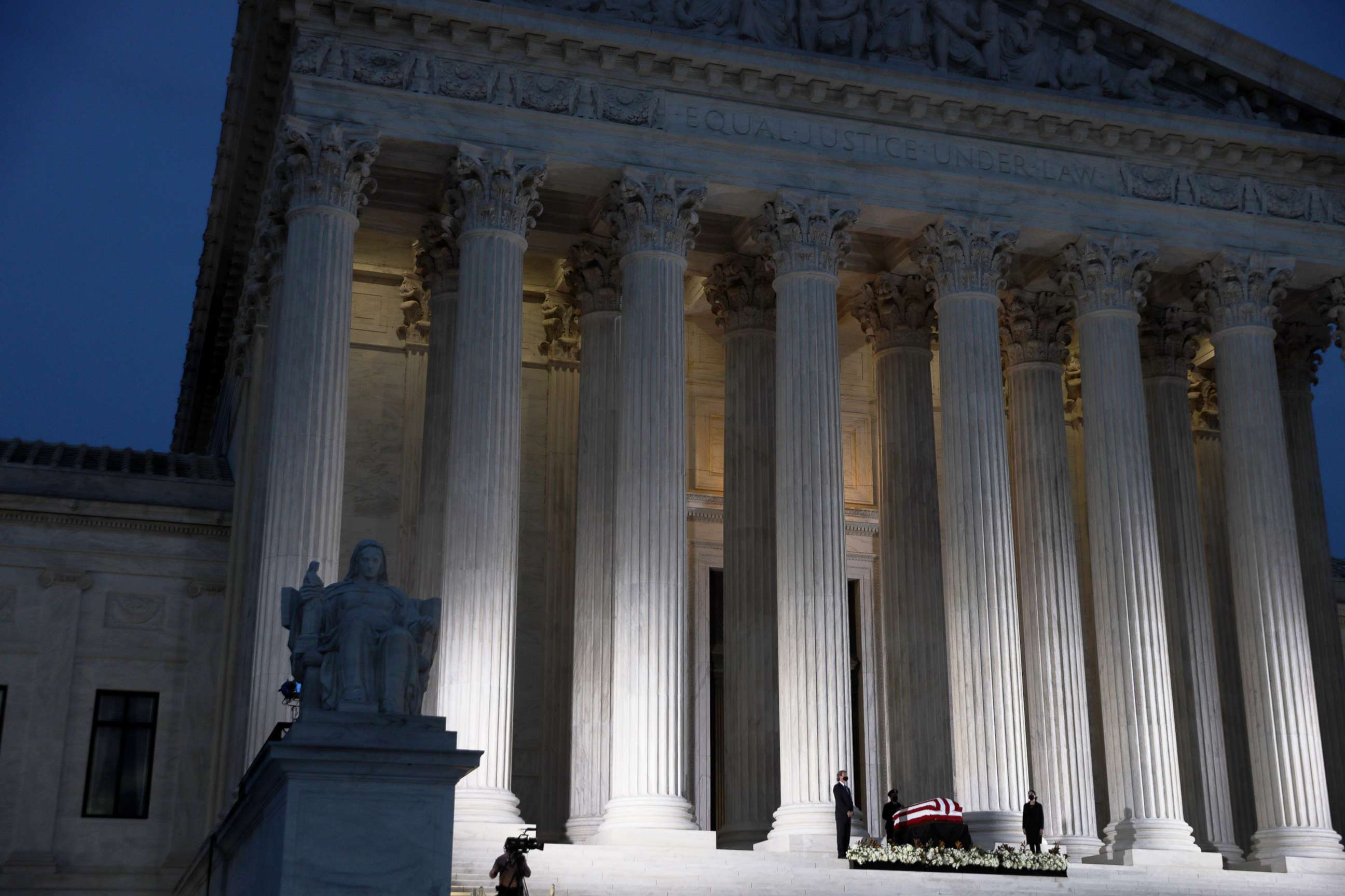 PHOTO: Members of the public pay respects to Associate Justice Ruth Bader Ginsburg as her flag-draped casket rests on the Lincoln catafalque on the west front of the U.S. Supreme Court, Sept. 23, 2020, in Washington, DC.