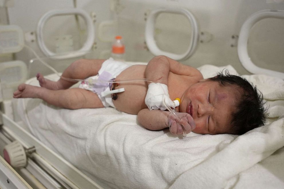 PHOTO: A newborn, who was found still tied by her umbilical cord to her mother and pulled alive from the rubble of a home in northern Syria following a deadly earthquake, receives medical care at a clinic in Afrin on Feb. 7, 2023.