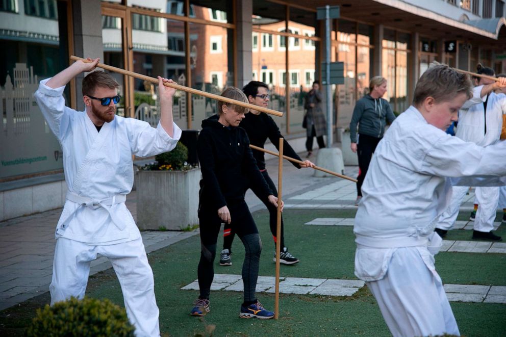 PHOTO: People practice Aikido outside their club studio, amid the coronavirus disease (COVID-19) outbreak, in central Stockholm, Sweden, April 20, 2020. 