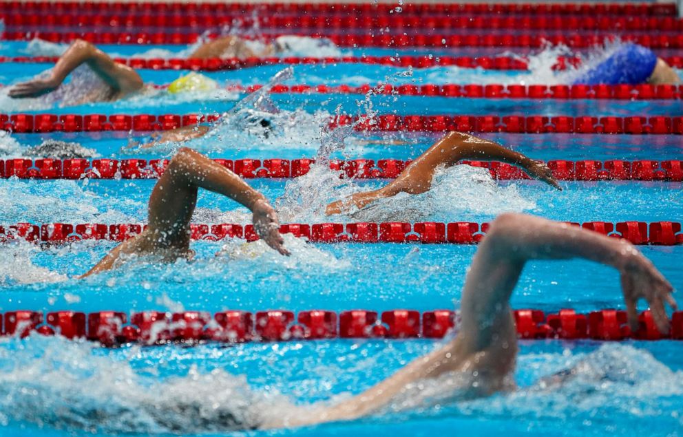 PHOTO: Swimmers compete in a men's 1500-meter freestyle heat at the 2020 Summer Olympics, Friday, July 30, 2021, in Tokyo, Japan.