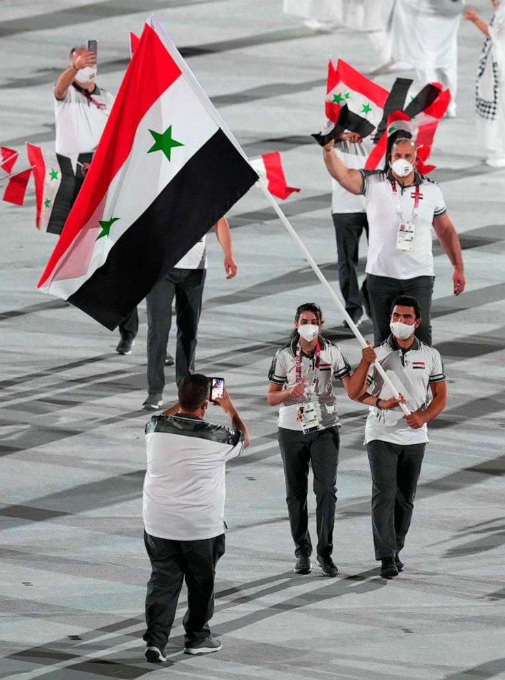 PHOTO: Flagbearers Hend Zaza and Ahmad Saber Hamcho lead out the Syria's team during the opening ceremony of the Tokyo 2020 Olympic Games at the Olympic Stadium in Japan. Picture date: Friday July 23, 2021.
