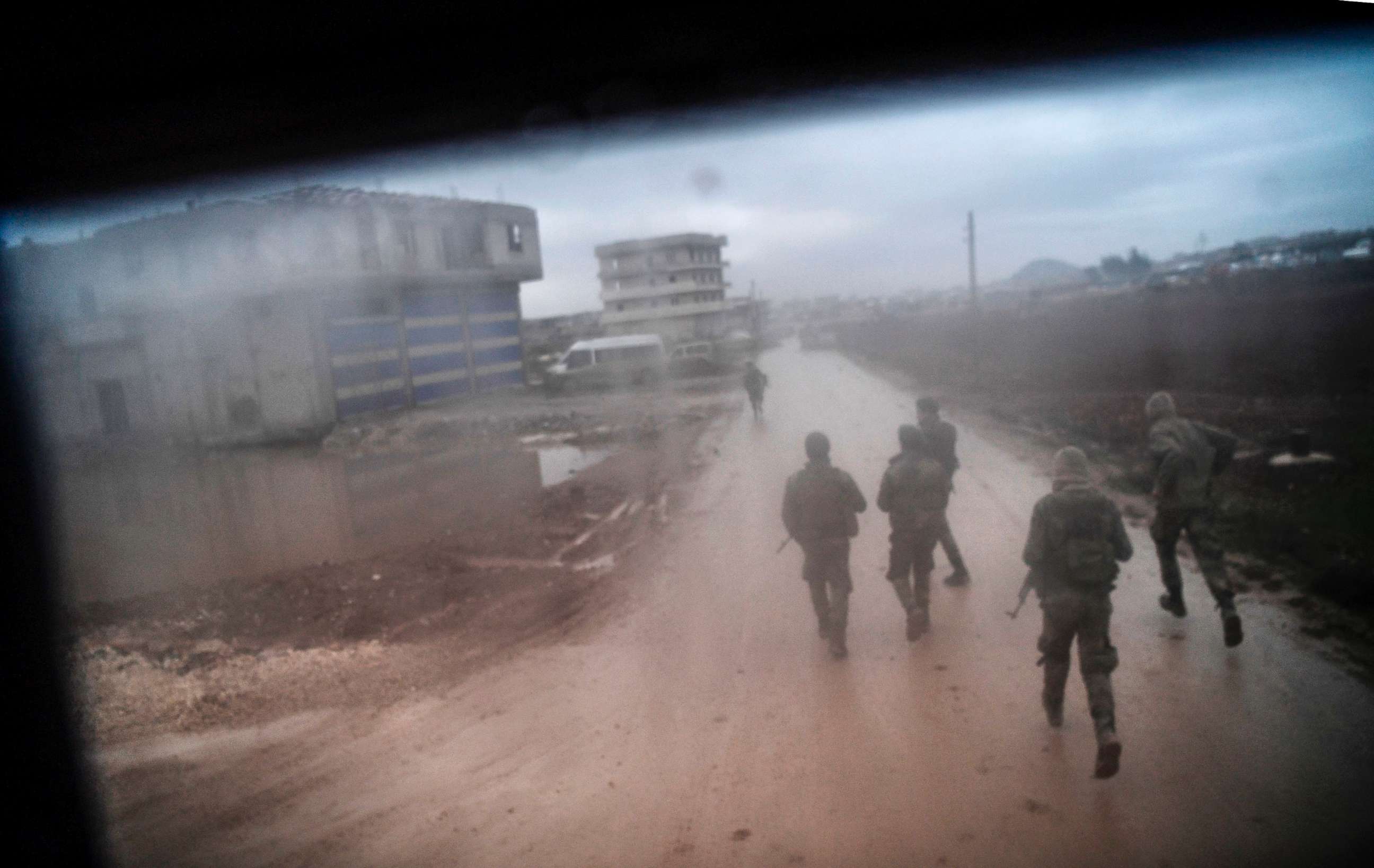 PHOTO: Turkish-backed Syrian rebel fighters are seen through the window of a Turkish armed vehicle on Jan. 26, 2018 at the Syrian town of Azaz.