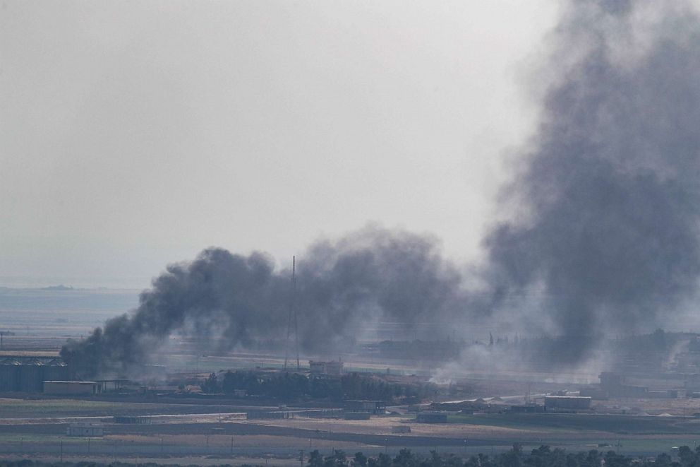 PHOTO: Smoke rises over the Syrian town of Ras al-Ain, as seen from the Turkish border town on October 18, 2019 in Ceylanpinar, Turkey.