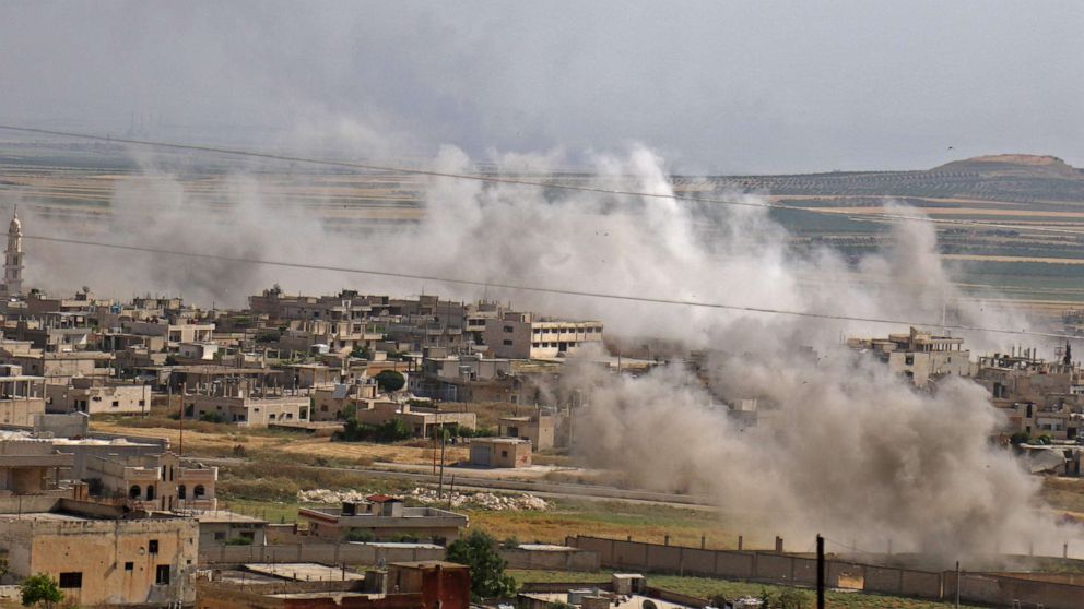 PHOTO: Smoke plumes are seen following a reported Syrian government forces' bombardment on the town of Khan Sheikhun in the southern countryside of the rebel-held Idlib province, May 22, 2019. 