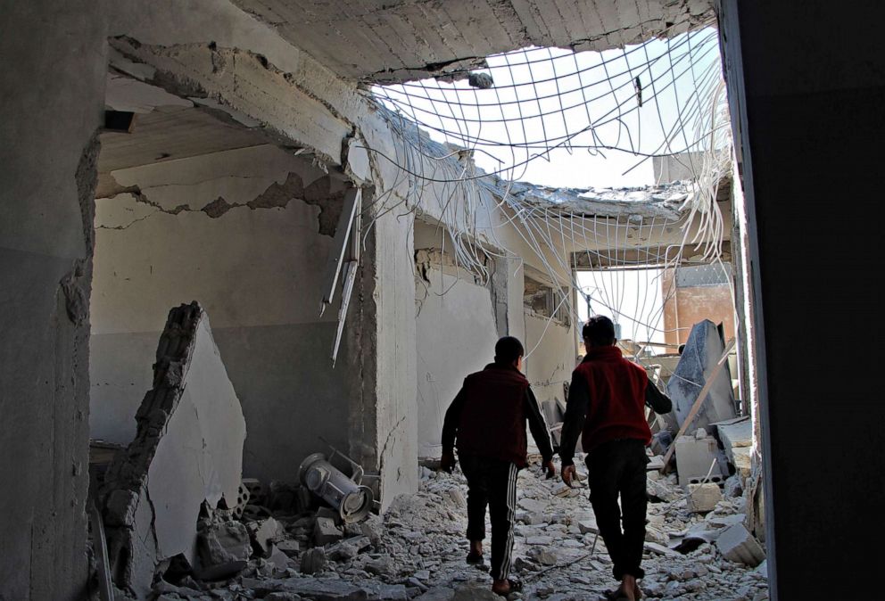 PHOTO: Displaced Syrian children walk through a destroyed school, reportedly targeted in a regime forces' air strike, in northwestern Idlib province on March 3, 2020, near the town of Adwan in Syria.