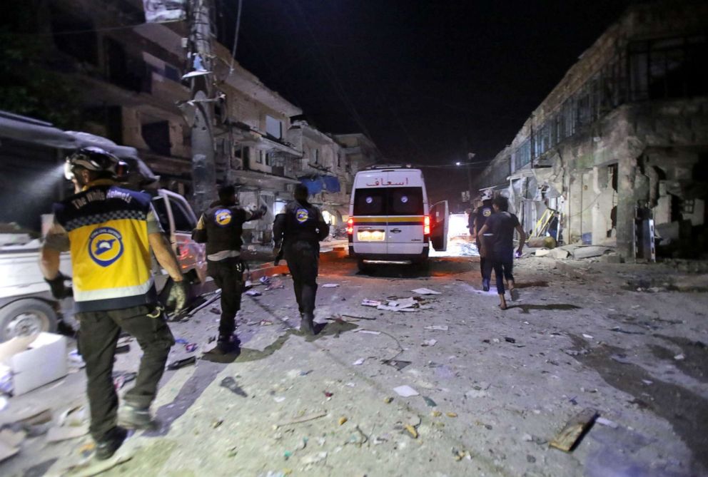 PHOTO: White Helmets rescue volunteers gather at the site of an air strike on a market in the town of Maarat al-Numan, May 21, 2019.At least 12 people were killed and 18 others wounded in overnight strikes on the Idlib town of Maarat al-Numan.