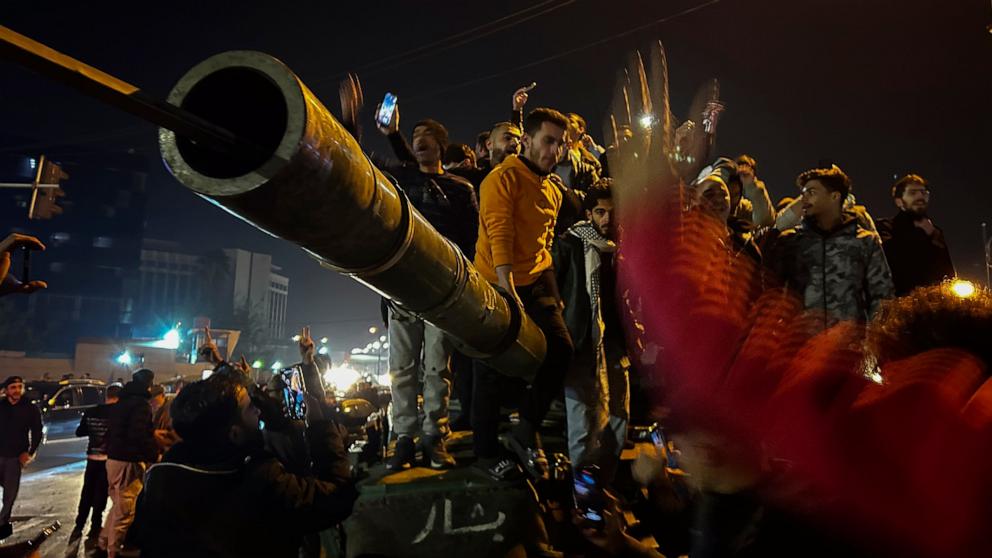 PHOTO: Syrians celebrate the arrival of opposition fighters in Damascus, Syria, Dec. 8, 2024. 