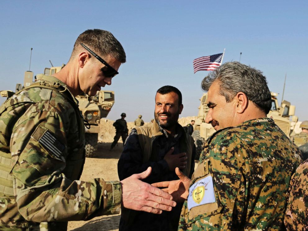 PHOTO: U.S. Army Maj. Gen. Jamie Jarrard left, thanks Manbij Military Council commander Muhammed Abu Adeel during a visit to a small outpost near the town of Manbij, northern Syria, Feb. 7, 2018.