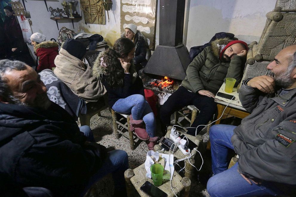 PHOTO: Syrians gather at a convent around a fire to spend the night as they fear more tremors following a deadly earthquaked on Feb. 6, 2023, in Aleppo.