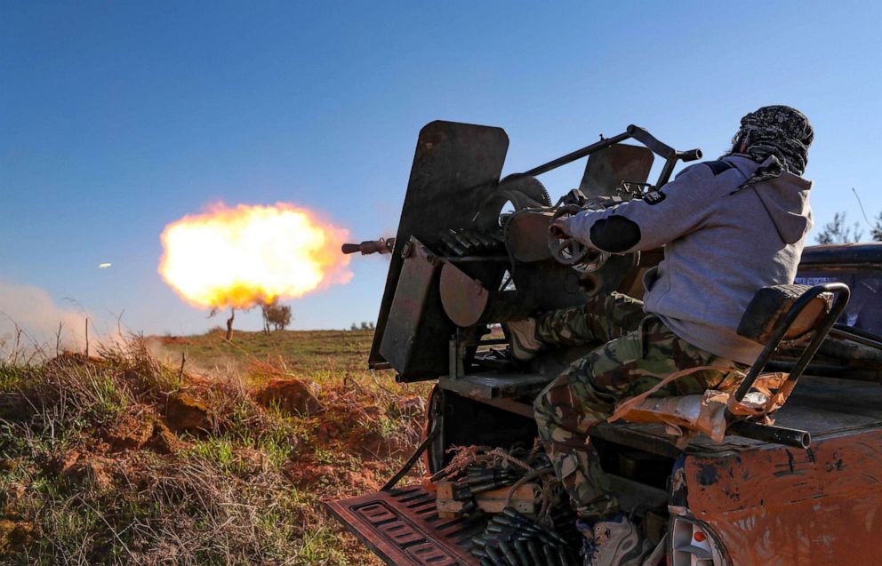 PHOTO: A Turkey-backed Syrian fighter fires a truck-mounted gun toward the town of Saraqeb from the outskits of the villages of Afis and Salihiyah situated near the regime-controlled town, in Idlib, Syria, Feb. 26, 2020.