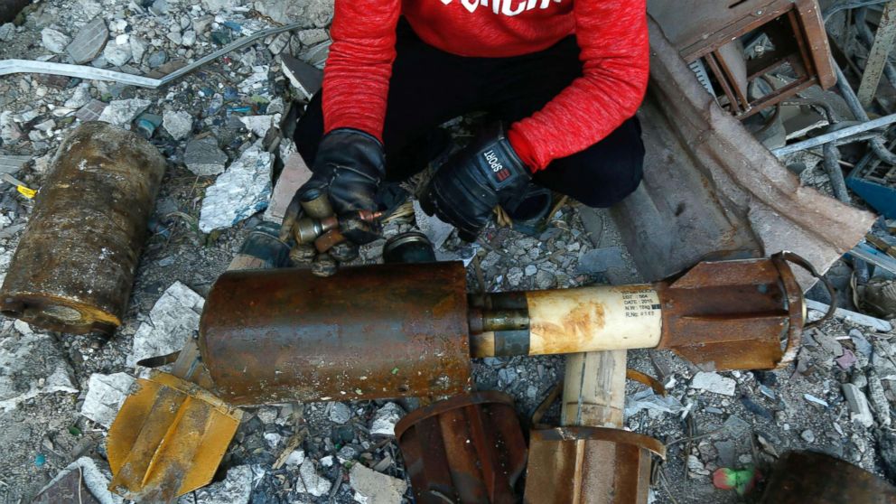 PHOTO: A Syrian man shows remnants of rockets reportedly fired by regime forces on the rebel-held besieged town of Douma, in the eastern Ghouta region, on the outskirts of the capital Damascus on Jan. 22, 2018. 