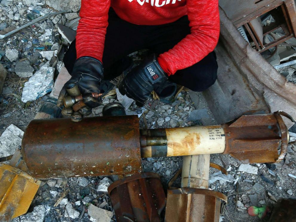 PHOTO: A Syrian man shows remnants of rockets reportedly fired by regime forces on the rebel-held besieged town of Douma, in the eastern Ghouta region, on the outskirts of the capital Damascus on Jan. 22, 2018.