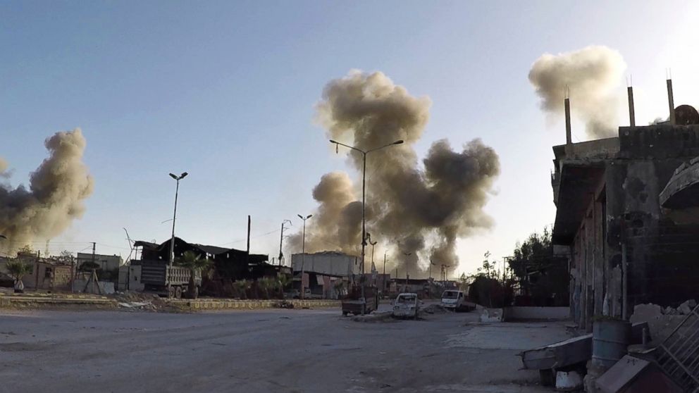 This photo released by the Syrian Civil Defense White Helmets, which has been authenticated based on its contents and other AP reporting, shows smoke rising after Syrian government airstrikes hit in the town of Douma, in Syria, Saturday, April. 7, 2018. 