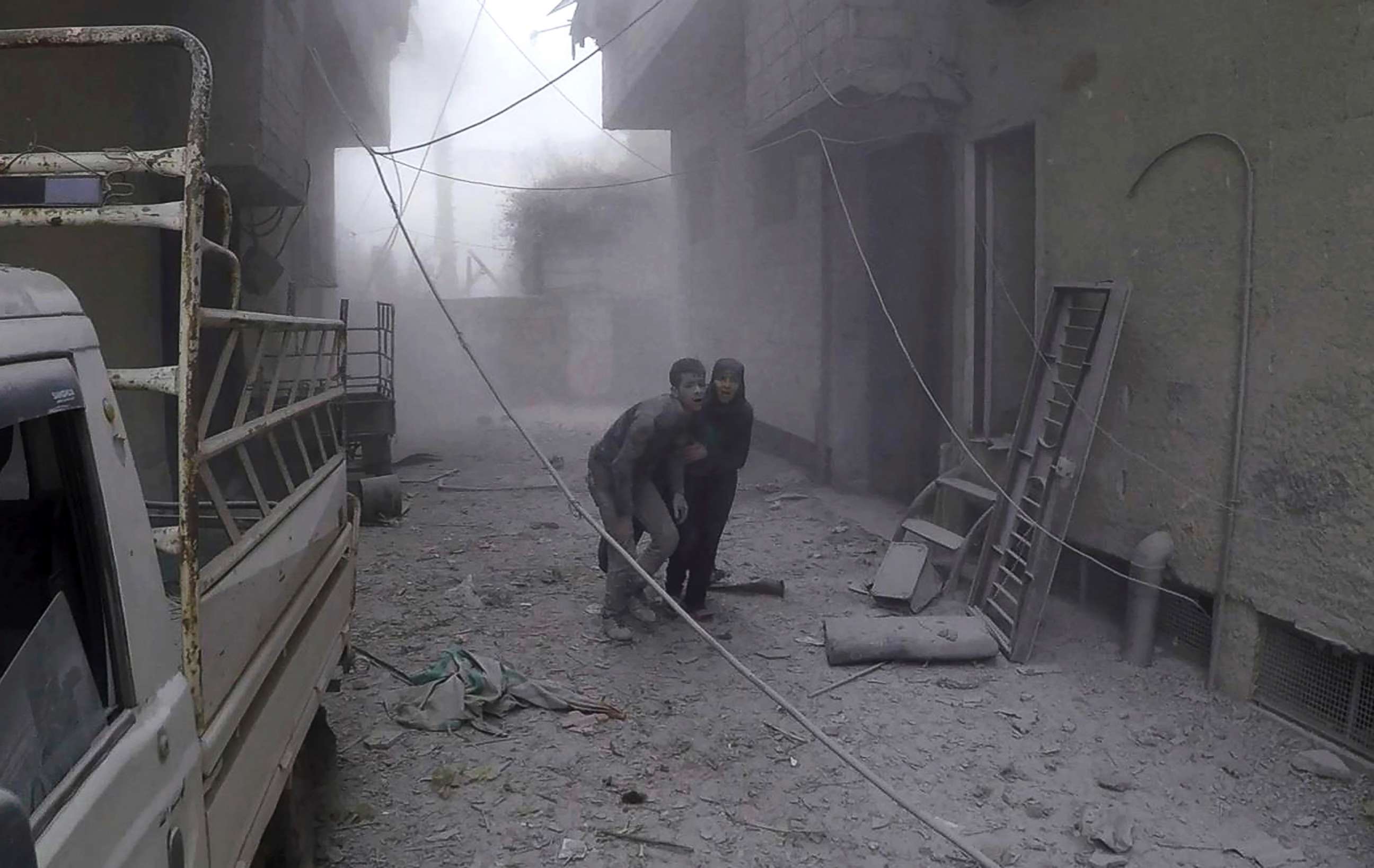 PHOTO: Civilians flee after airstrikes hit a rebel-held suburb near Damascus, Syria, Feb. 5, 2018.