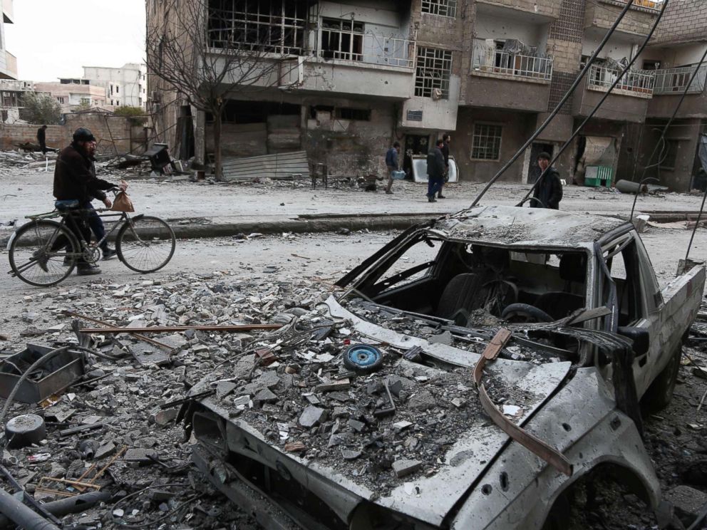 PHOTO: Syrians walk along a street covered in debris in Eastern Ghouta, Syria, Feb. 25, 2018.
<p itemprop=