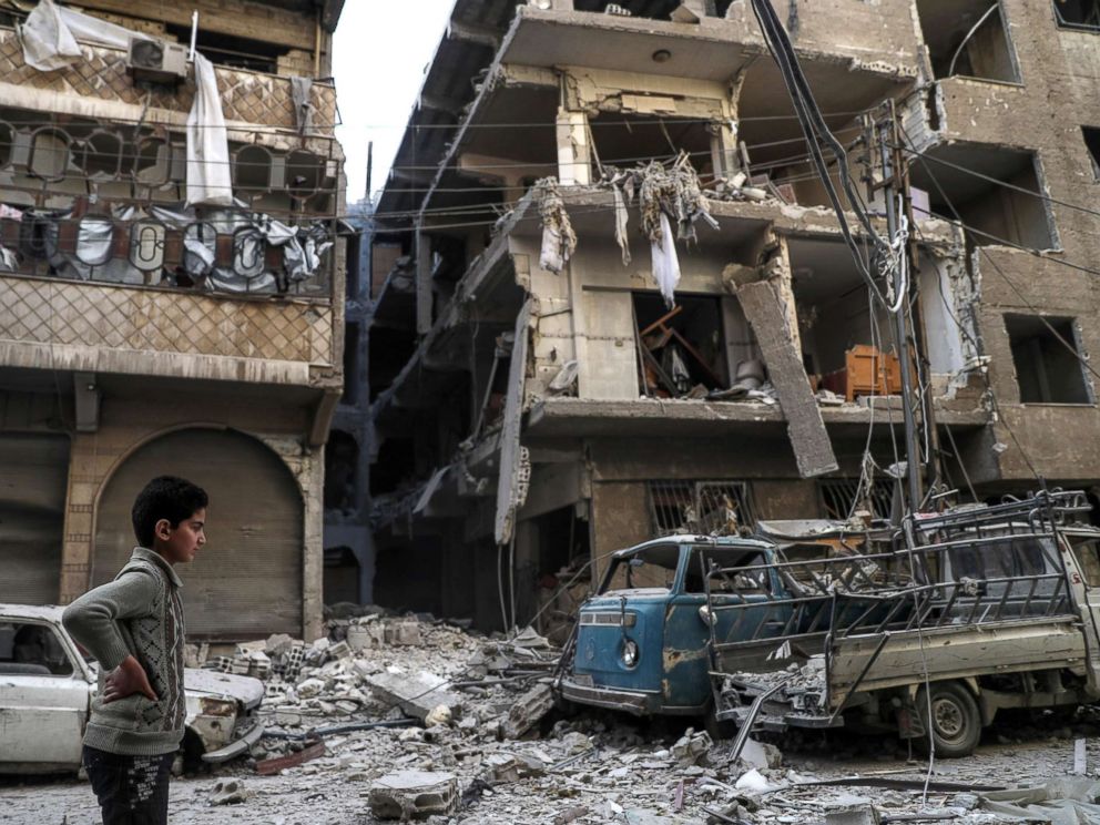 PHOTO: A boy surveys a street covered in rubble after air strikes in Douma, Syria, Nov. 17. 2017, that killed at least thirteen civilians, including three white helmets volunteers, according to local sources.