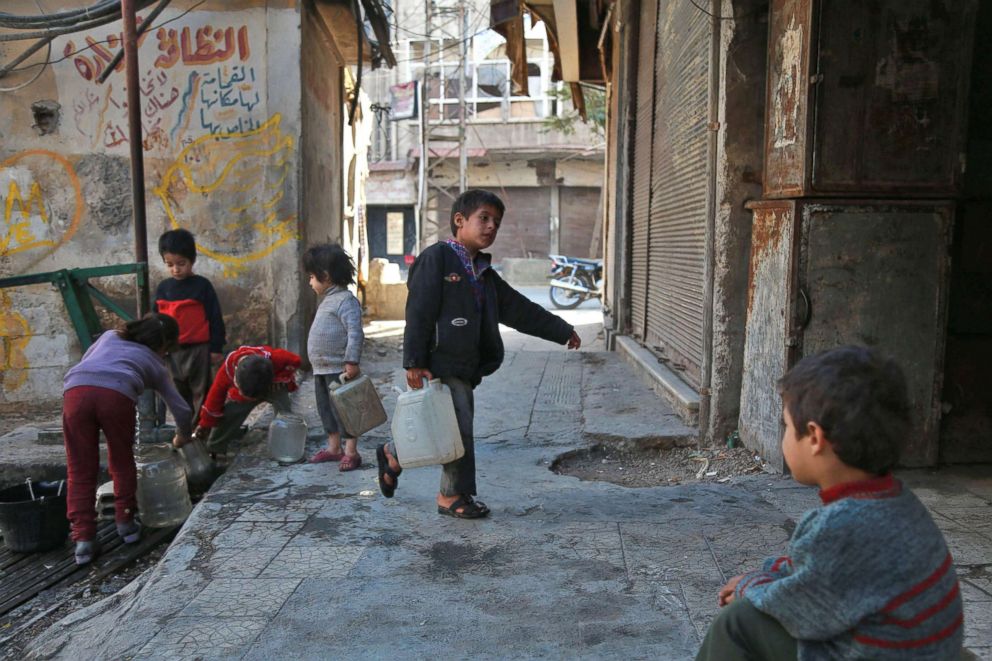 PHOTO: Children collect water, Nov. 6, 2017 in Saqba, in the besieged rebel-held Eastern Ghouta area near Damascus, where residents and relief groups have warned a humanitarian crisis is escalating.