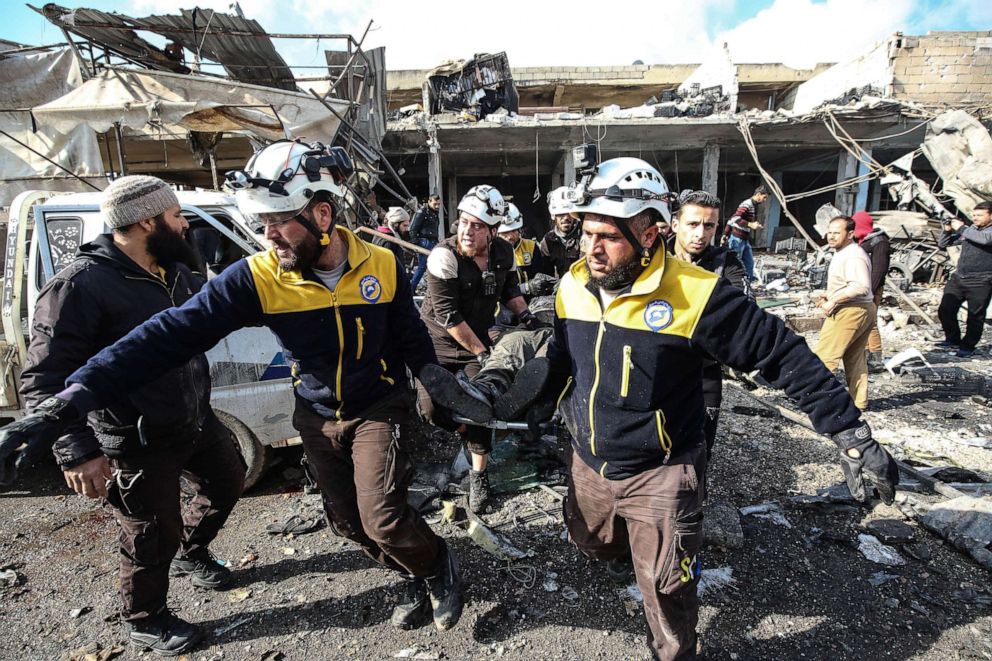 PHOTO: White Helmets and locals conduct search and rescue works at a debris of a building after Assad Regime forces carried out airstrikes that targeted a marketplace in Idlib's Marratinnuman town, Syria, Dec. 2, 2019. 