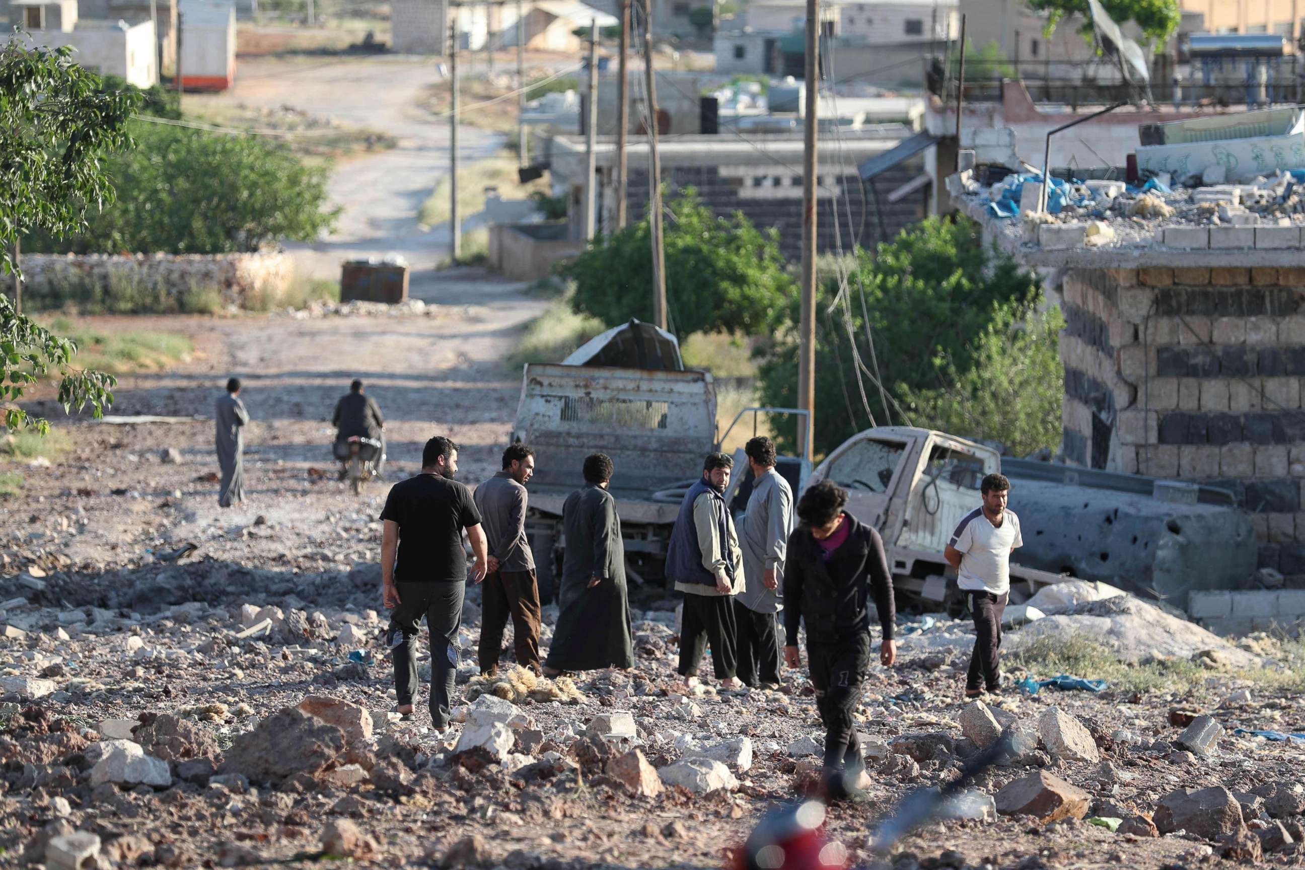 PHOTO: People gather amidst the rubble and damaged vehicles following reported airstrikes by the Syrian regime ally Russia, in the town of Kafranbel in the rebel-held part of the Syrian Idlib province, May 20, 2019.
