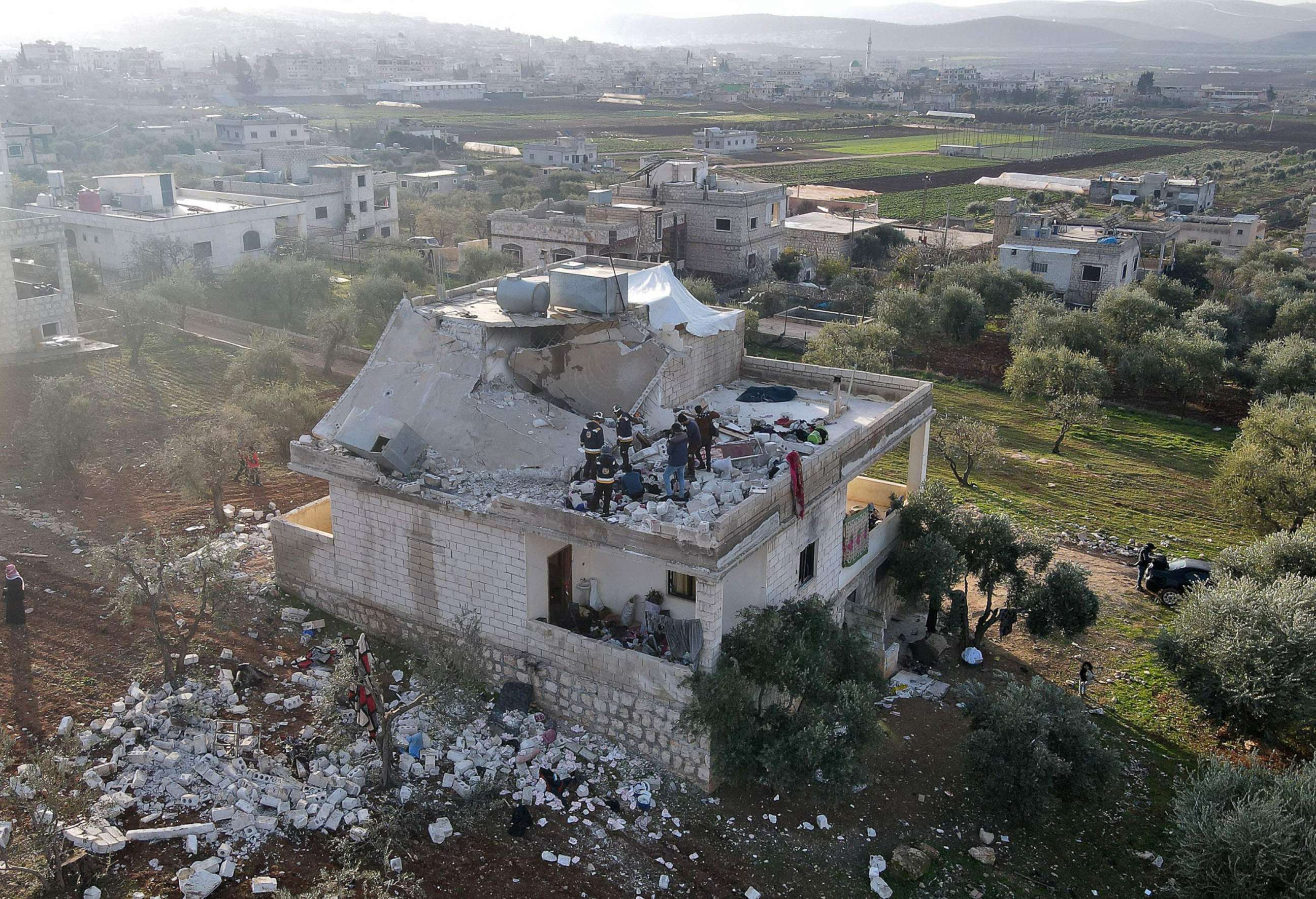 PHOTO: Syrians gather on Feb.3, 2022 at the scene following an overnight counterterrorism mission carried out by U.S. special operations forces in northwestern Syria.