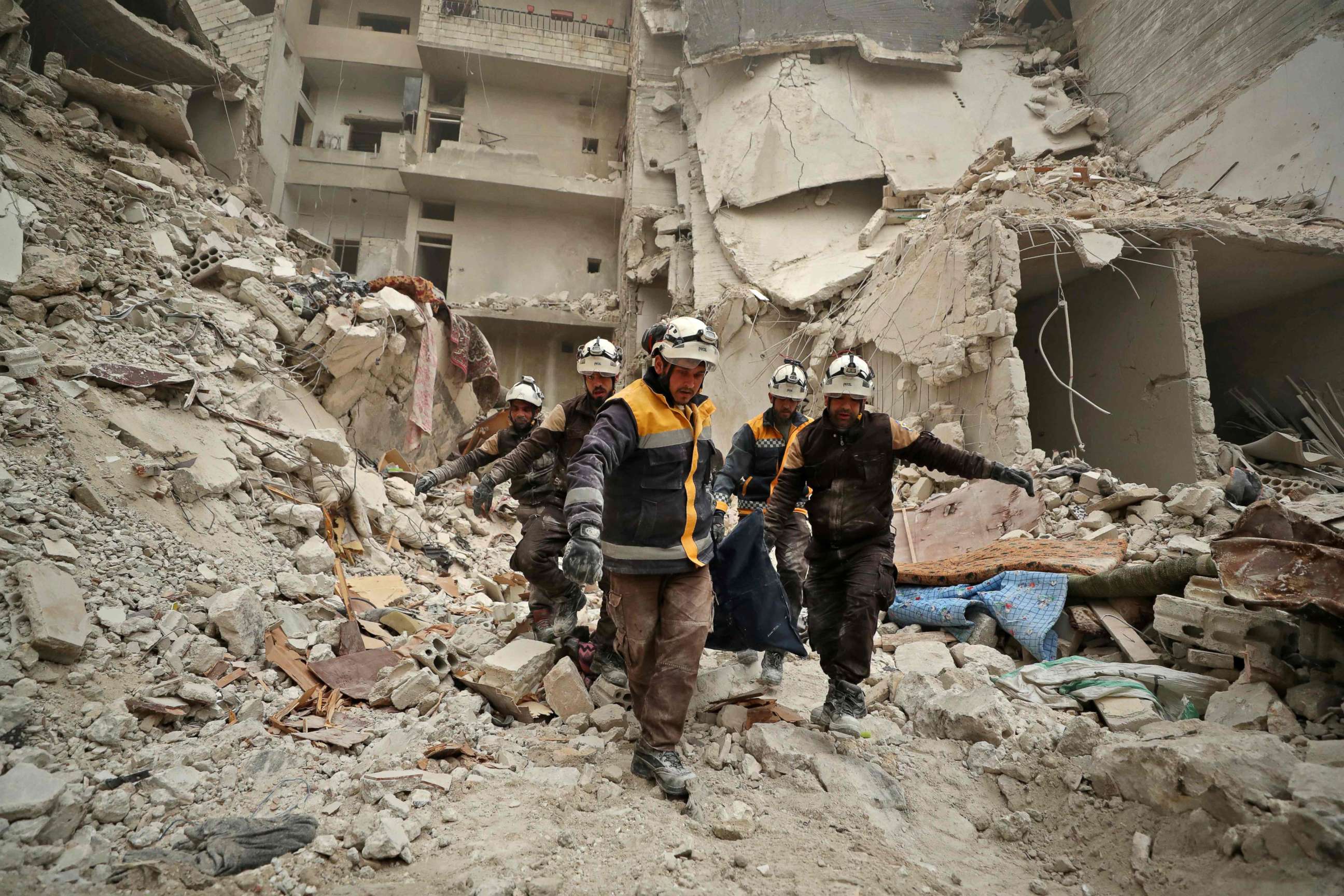 PHOTO: Rescue workers known as the White Helmets carry away the body of a victim found amidst the rubble of a building, hit during an air strike by pro-regime forces on the rebel-held town of Ariha, Idlib province, Syria, Feb. 5, 2020.