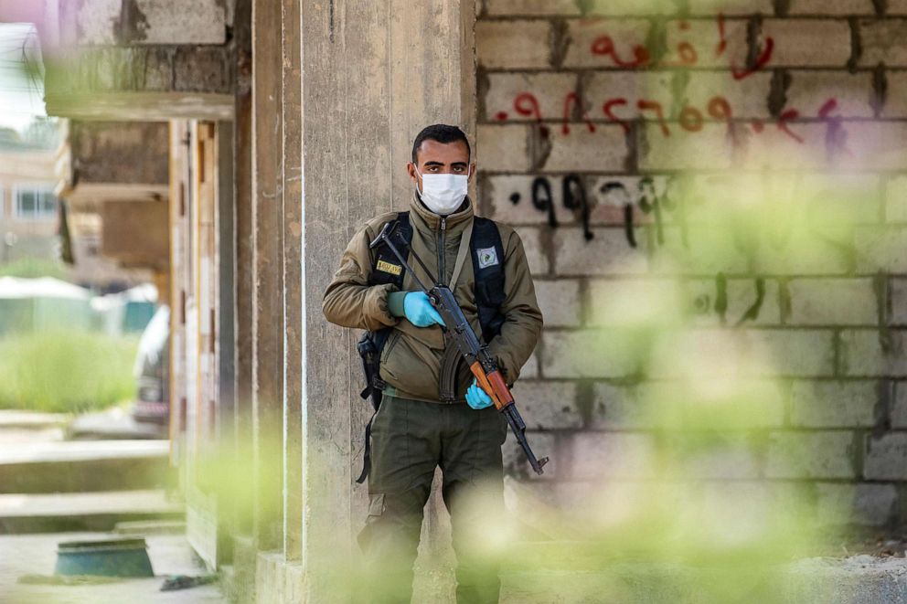 PHOTO: A member of the Kurdish Internal Security Forces of Asayesh stands guard on a deserted street in Syria's northeastern city of Hasakeh on April 30, 2020, following measures taken by the Kurdish-led authorities to limit the spread of the coronavirus.