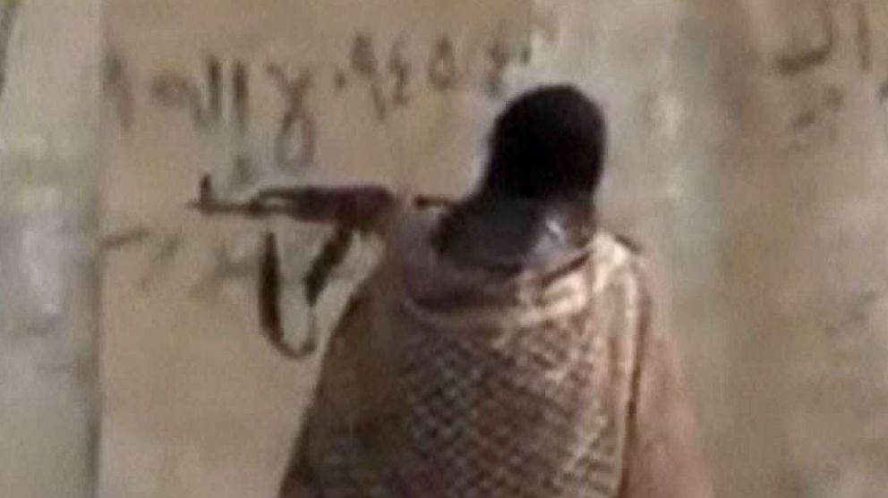 PHOTO: A still image taken from a video posted to a social media website by the Islamic State-affiliated Amaq News Agency, on July 15, 2017, shows a man appearing to be an Islamic State militant firing a weapon, said to be in Raqqa, Syria. 