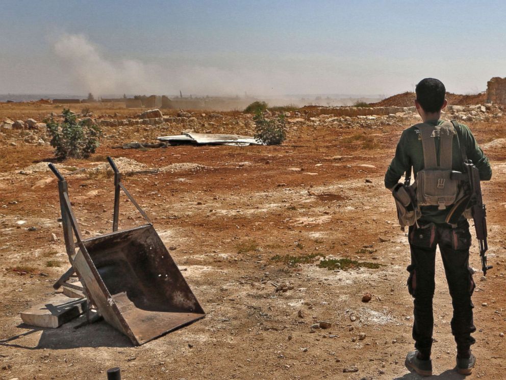 PHOTO: A Syrian rebel fighter watches smoke rising from an explosion in the northern countryside of the Idlib province, Sept. 5, 2018.